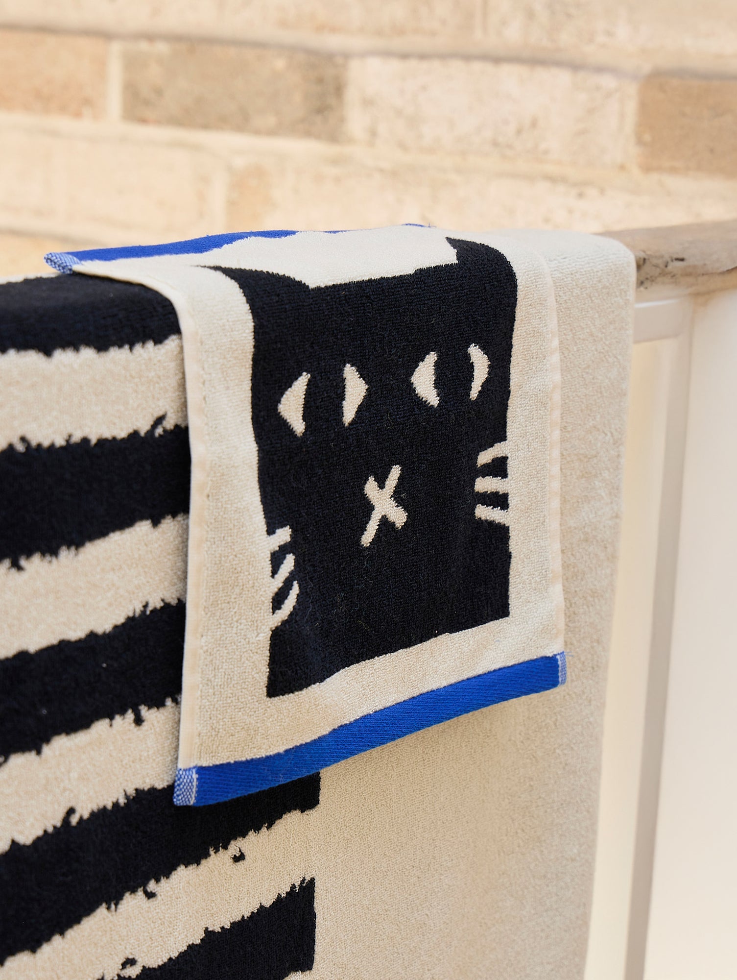Lazy Cat Face Towel by Donna Wilson